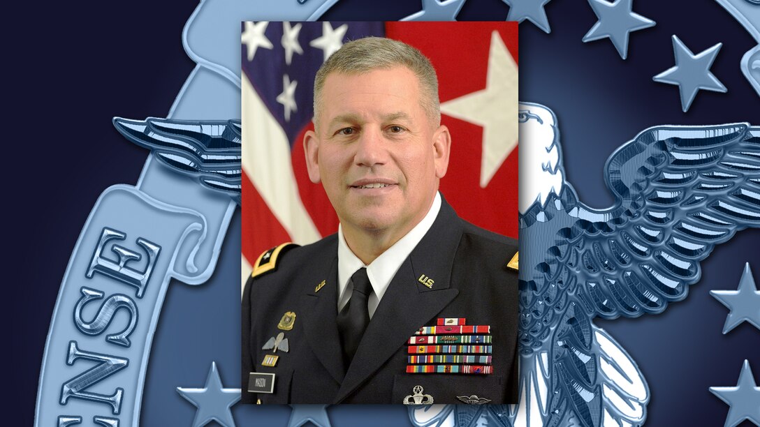 Army lieutenant general with flag in the background against DLA logo.