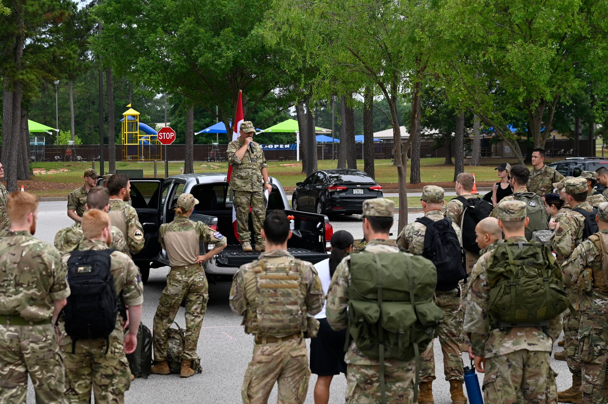 Royal Danish Air Force Lt. Col. John Roland Pedersen briefs rules and safety guidelines to members from the U.S. Air Force, U.S. Army, and Royal Danish Air Force as they prepare to begin the inaugural Danish Contingency (DANCON) ruck march at Shaw Air Force Base, S.C., June 5, 2021. Traditionally, RDAF members host 25KM (15.5 miles) DANCON ruck marches at the conclusion of team deployments in the Middle East and other locations around the globe. RDAF members recently deployed to Shaw Air Force Base to work side by side with Airmen from the 727 Expeditionary Air Control Squadron, “Kingpin,” and this event marks the first DANCON march held on U.S. soil.