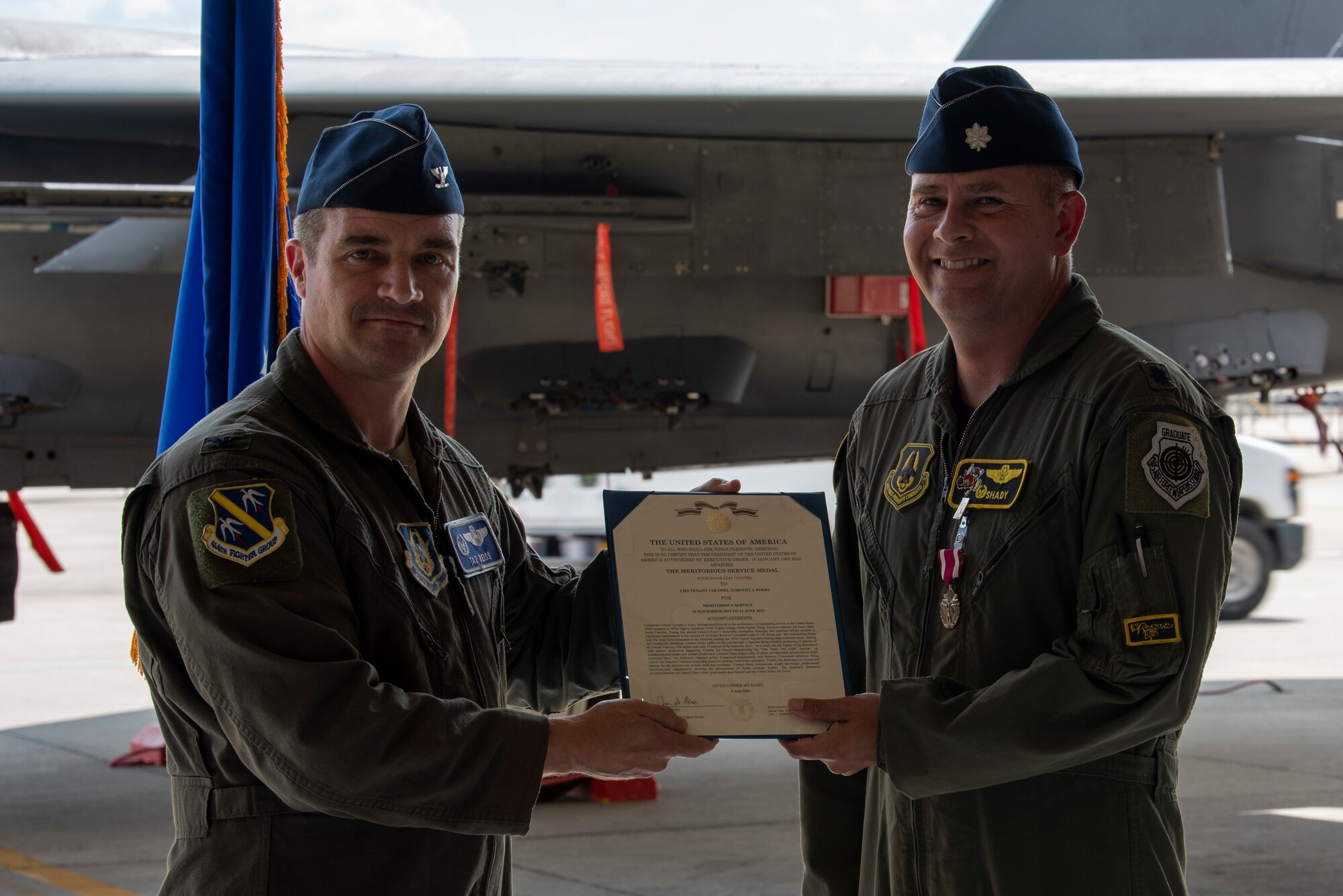 Lt. Col. Timothy Foery, outgoing 307th Fighter Squadron commander receives Meritorious Service Medal from Col. Jason Reiss 414th Fighter Group commander at Seymour Johnson Air Force Base, North Carolina, June 11, 2021.