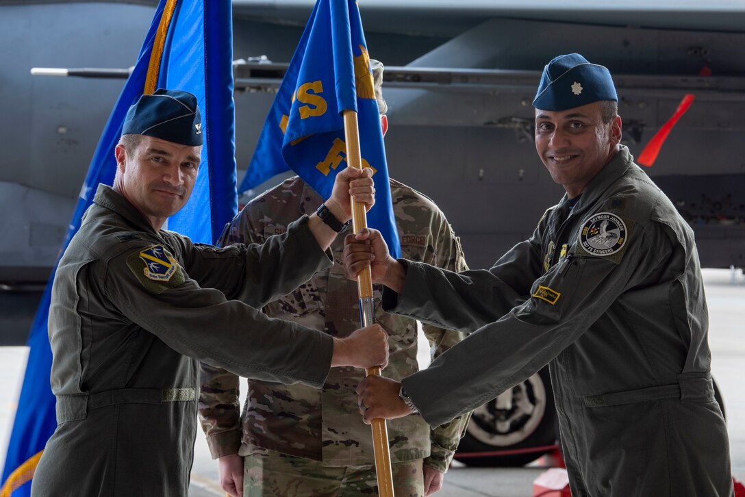 Lt. Col. Sriram Krishnan, incoming 307th Fighter Squadron commander, receives the guidon from Col. Jason Reiss 414th Fighter Group commander, during the 307th FS change of command ceremony at Seymour Johnson Air Force Base, North Carolina, June 11, 2021.