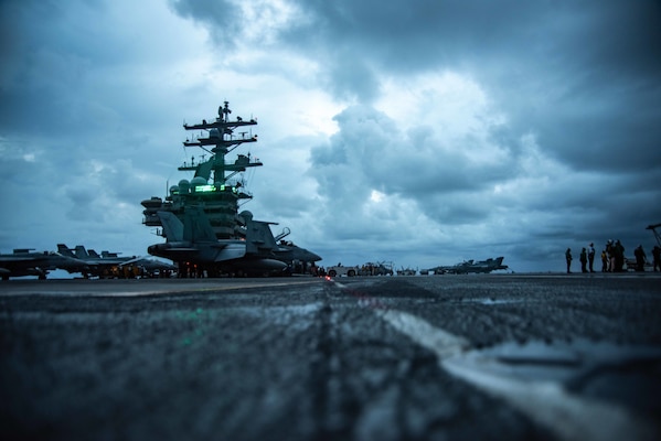 Sailors conduct flight operations on the flight deck of the U.S. Navy's only forward-deployed aircraft carrier USS Ronald Reagan (CVN 76).