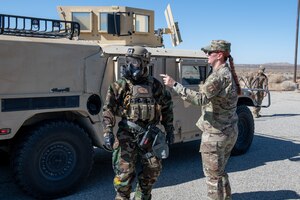 Technical Sgt. Monica D. Balcsik, right, noncommissioned officer in-charge, EOD training, 812 Civil Engineering Squadron, talks to Staff Sgt. Joseph Johnson, EOD Journeyman, 812th CES, during an 812th CES interoperability exercise on North Base at Edwards Air Force Base, California, June 4.