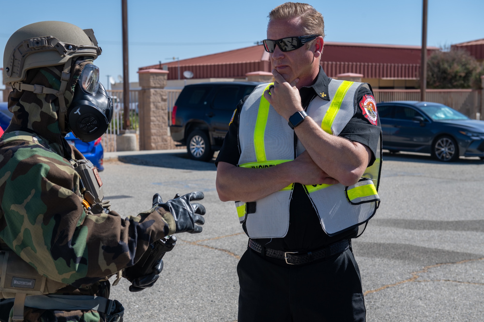 Staff Sgt. Joseph Johnson, left, EOD Journeyman, 812th Civil Engineering Squadron, talks to Ronald Watson, division chief, 812th CES and incident commander for the exercise, during an 812th CES interoperability exercise on North Base at Edwards Air Force Base, California, June 4.