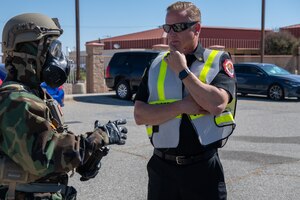 Staff Sgt. Joseph Johnson, left, EOD Journeyman, 812th Civil Engineering Squadron, talks to Ronald Watson, division chief, 812th CES and incident commander for the exercise, during an 812th CES interoperability exercise on North Base at Edwards Air Force Base, California, June 4.