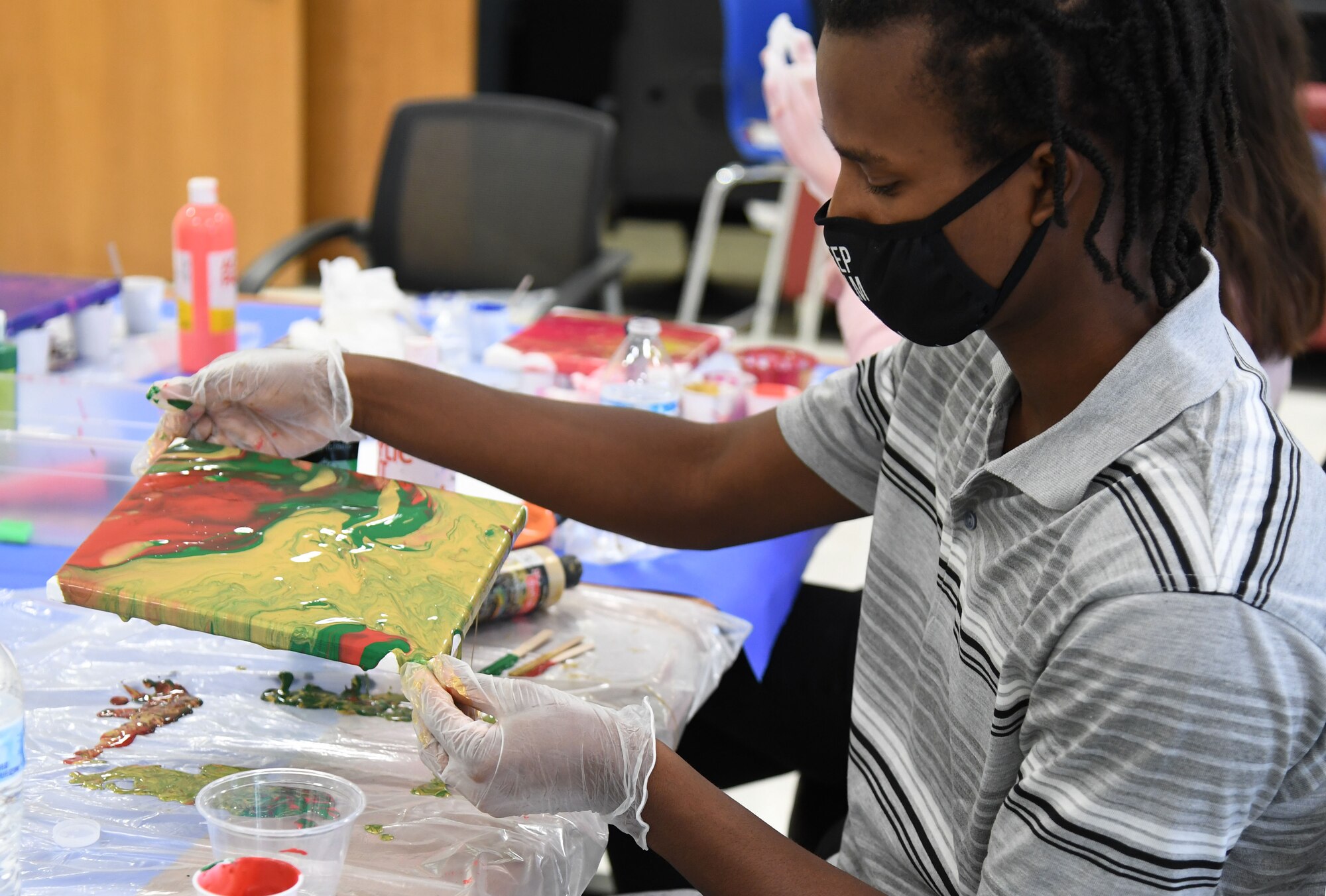 Brian Louis, son of Brian Louis, 81st Comptroller Squadron financial technician, uses acrylics to create a piece of art during the Keesler Youth Center fine arts camp at Keesler Air Force Base, Mississippi, June 10, 2021. The youth center offers a variety of camps throughout the summer for children of military personnel. (U.S. Air Force photo by Kemberly Groue)