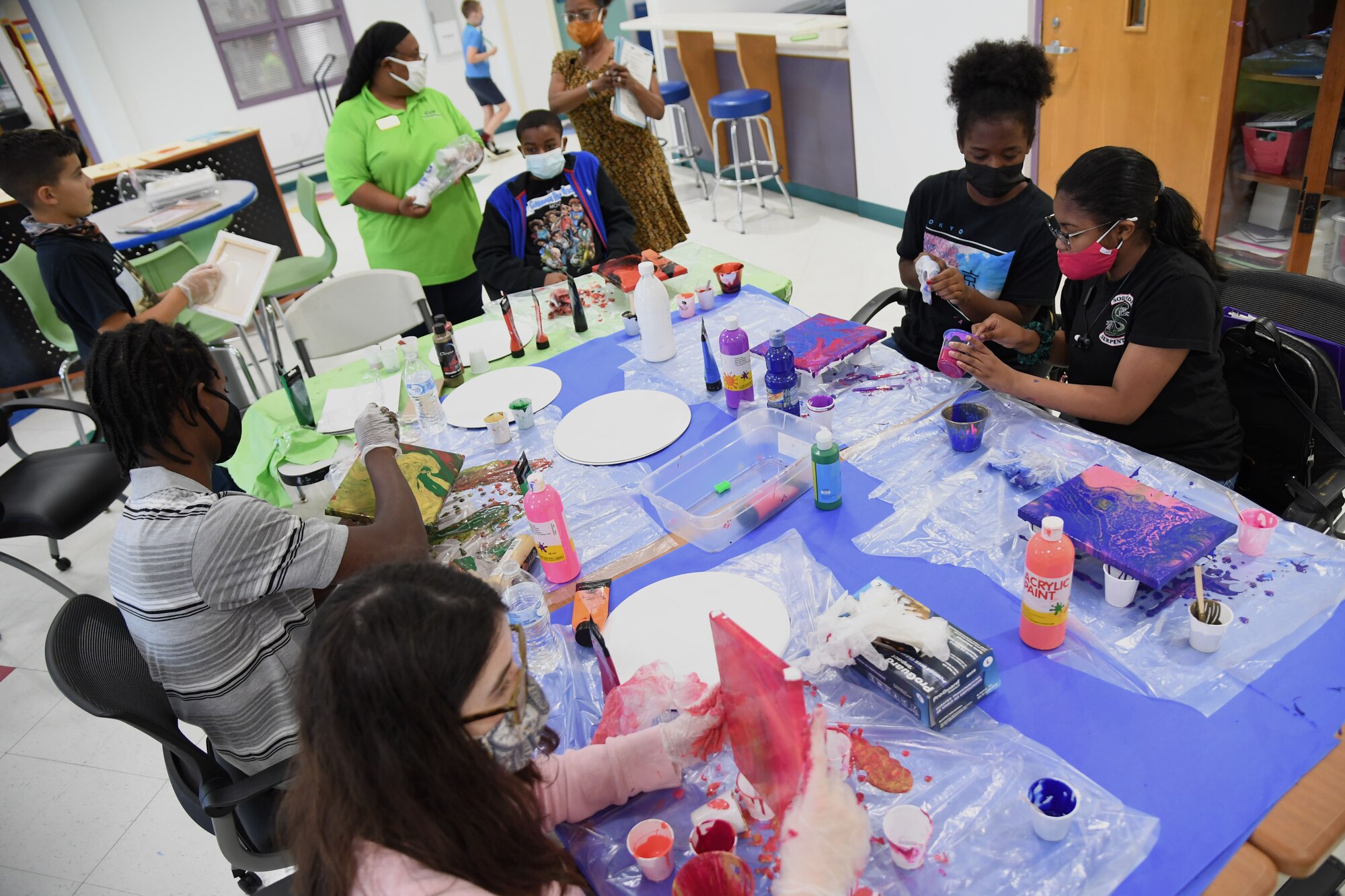 Children of military personnel uses acrylics to create art during the Keesler Youth Center fine arts camp at Keesler Air Force Base, Mississippi, June 10, 2021. The youth center offers a variety of camps throughout the summer for children of military personnel. (U.S. Air Force photo by Kemberly Groue)