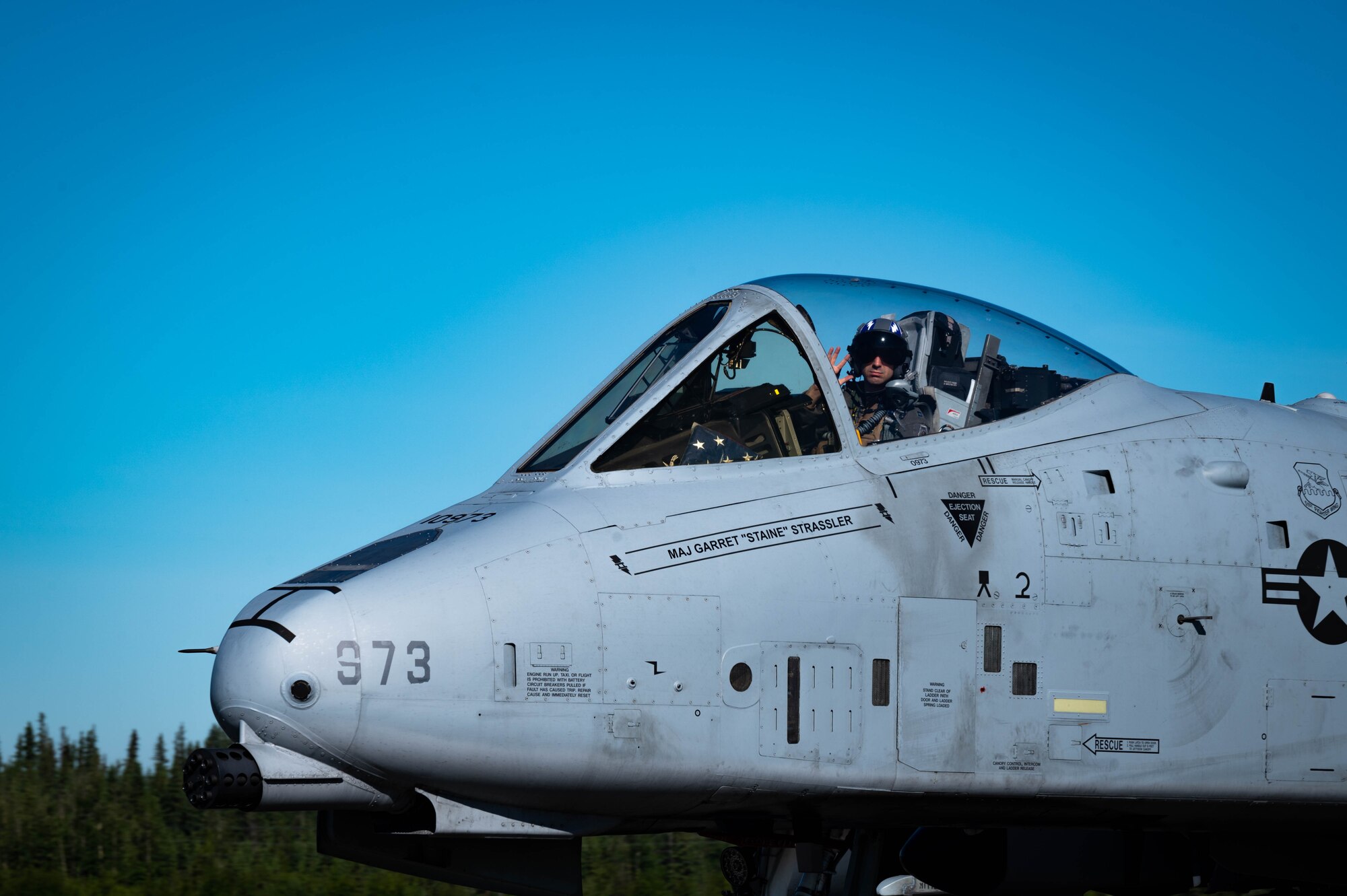 An A-10 Thunderbolt II pilot assigned to the 25th Fighter Squadron, Osan Air Base, Republic of Korea, waves during RED FLAG-Alaska 21-2 on Eielson Air Force Base, Alaska, June 14, 2021.