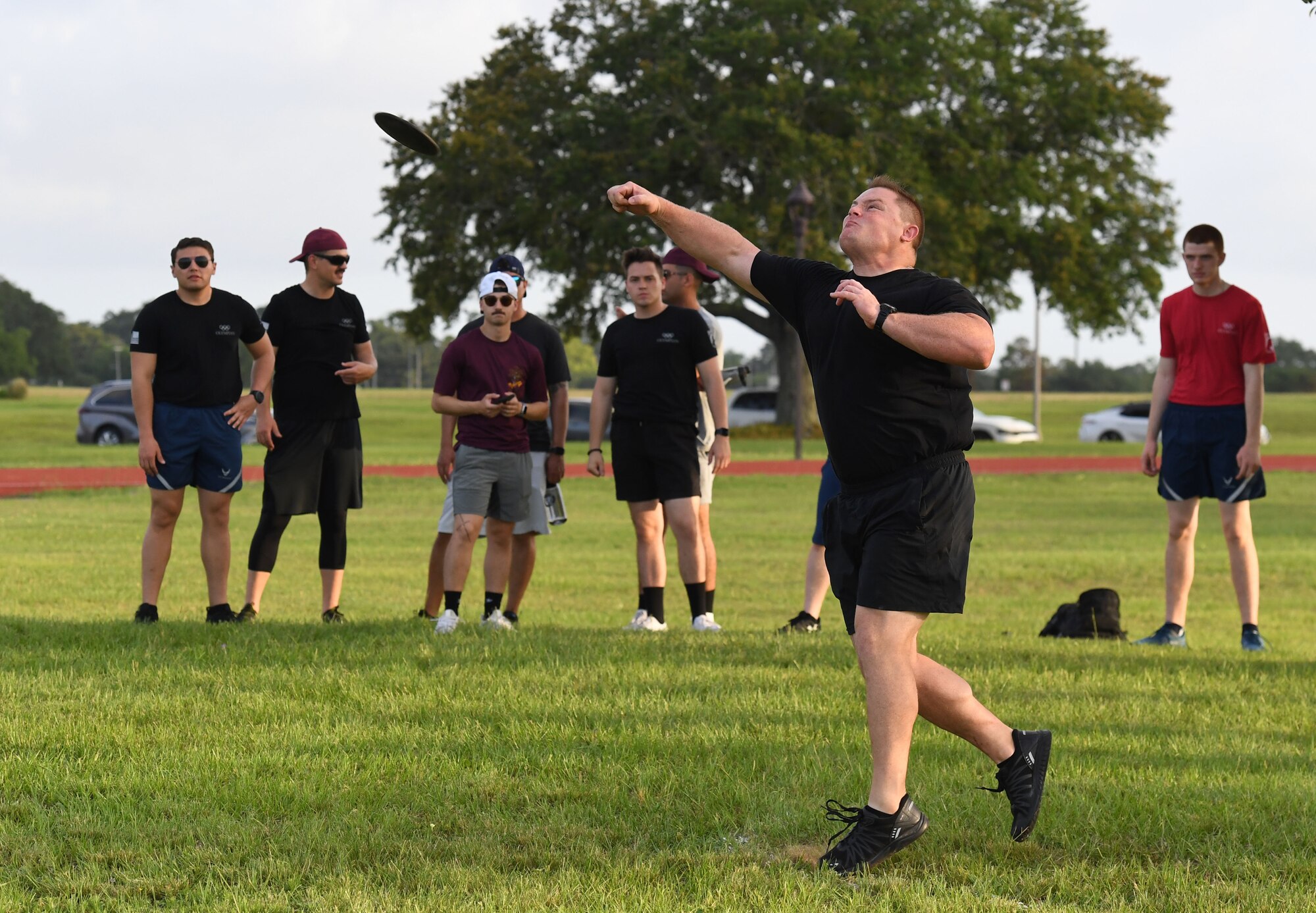 U.S. Air Force Airman 1st Class George Weed, 338th Training Squadron student, throws a discus during the 81st Training Group Olympics at Keesler Air Force Base, Mississippi, June 11, 2021. The event also included competitions in weight lifting, long jump, track and shot put. (U.S. Air Force photo by Kemberly Groue)