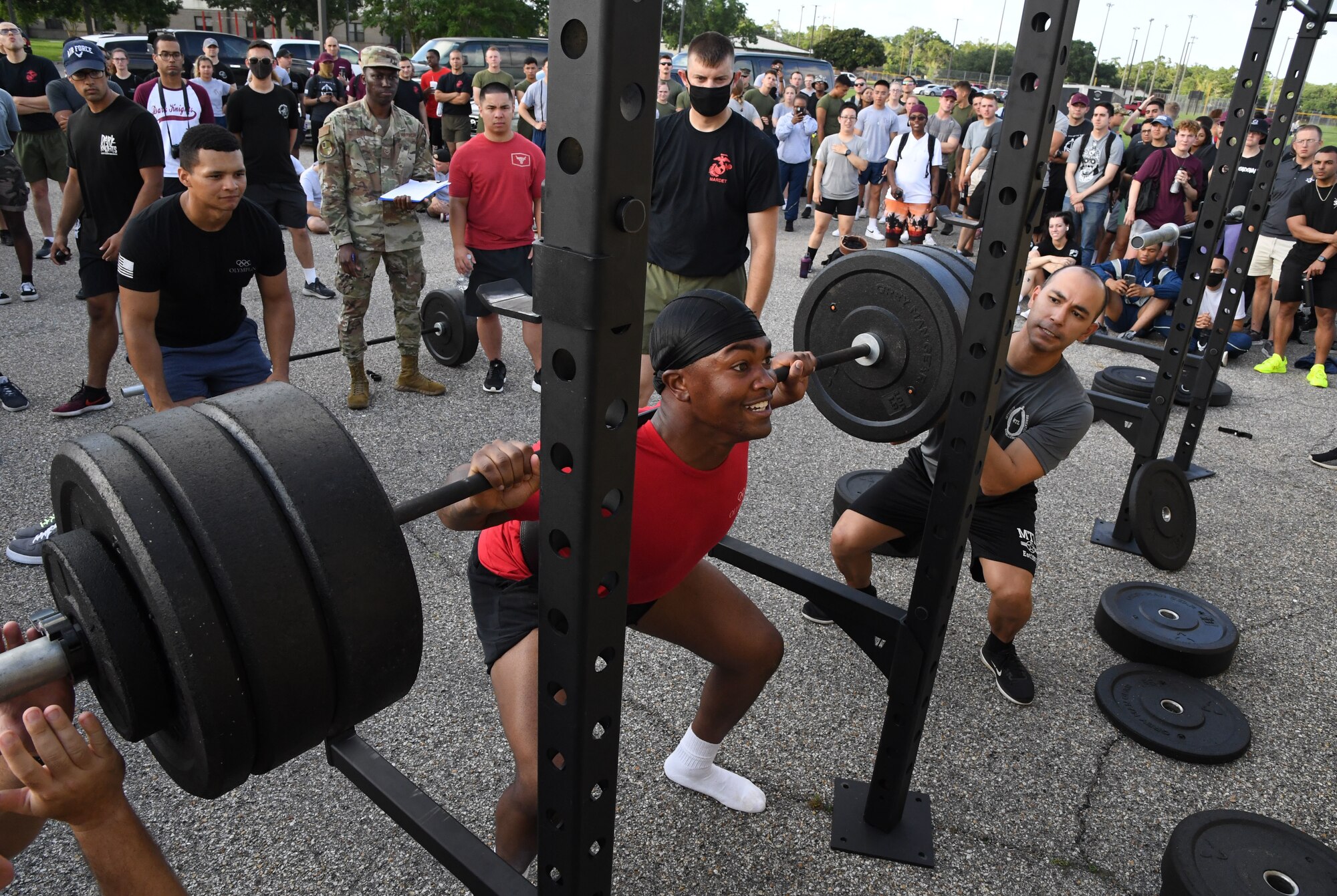 U.S. Air Force Airman Judah Officer, 336th Training Squadron student, participates in squats during the 81st Training Group Olympics at Keesler Air Force Base, Mississippi, June 11, 2021. The event also included competitions in long jump, track, shot put and discus. (U.S. Air Force photo by Kemberly Groue)