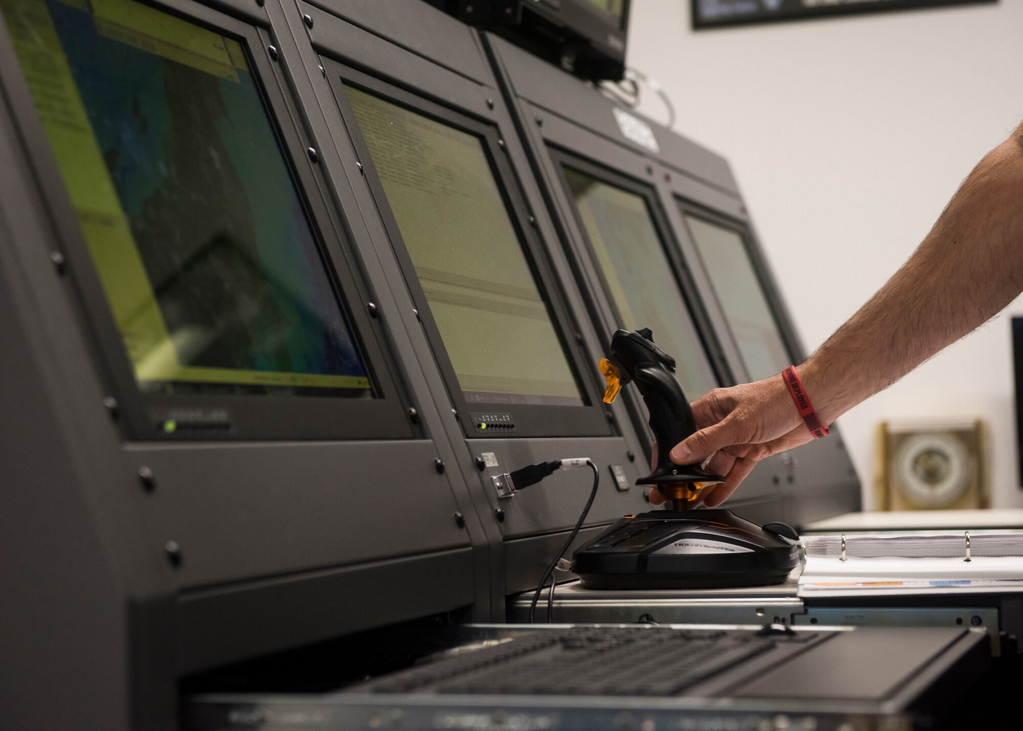 Man holds a joystick operating a Joint Threat Emitter from the Command and Control Unit.