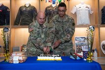 Military members cut Army birthday cake with sword