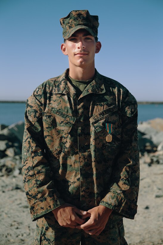U.S. Marine Corps Cpl. Jordan Perez receives the Navy and Marine Corps Achievement Medal