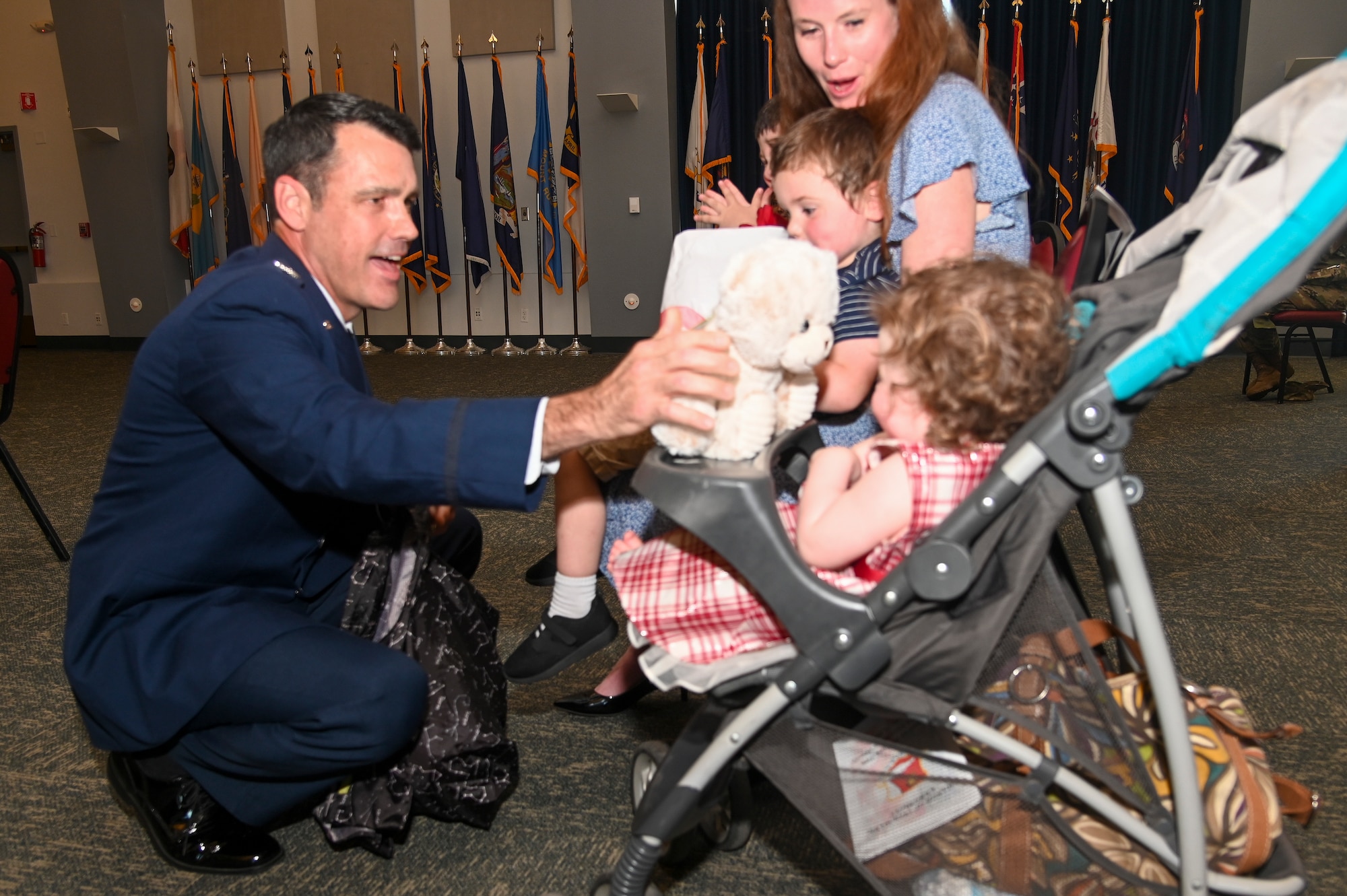 Col. Erik Aufderheide, 940th Air Refueling Wing commander, gives his family gifts during a change of command ceremony June 12, 2021, at Beale Air Force Base, California.