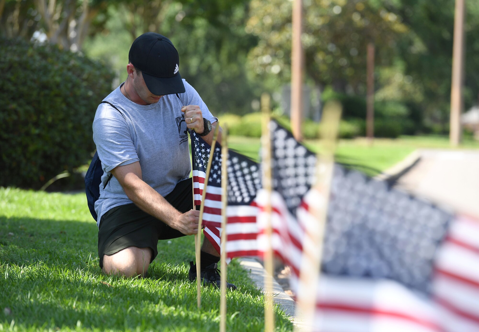 U.S. Air Force Airman 1st Class Michael Hanson, 338th Training Squadron student and member of the Air Force Sergeants Association Chapter 652, places a U.S. flag in the ground along Larcher Blvd. at Keesler Air Force Base, Mississippi, June 11, 2021. June 14 is Flag Day, a celebration of the history of the American flag and a time to remember proper etiquette for its display. Flag Day recognizes the adoption of the Stars and Stripes as the official flag of the United States 238 years ago on June 14, 1777, by the Continental Congress meeting in Philadelphia. (U.S. Air Force photo by Kemberly Groue)