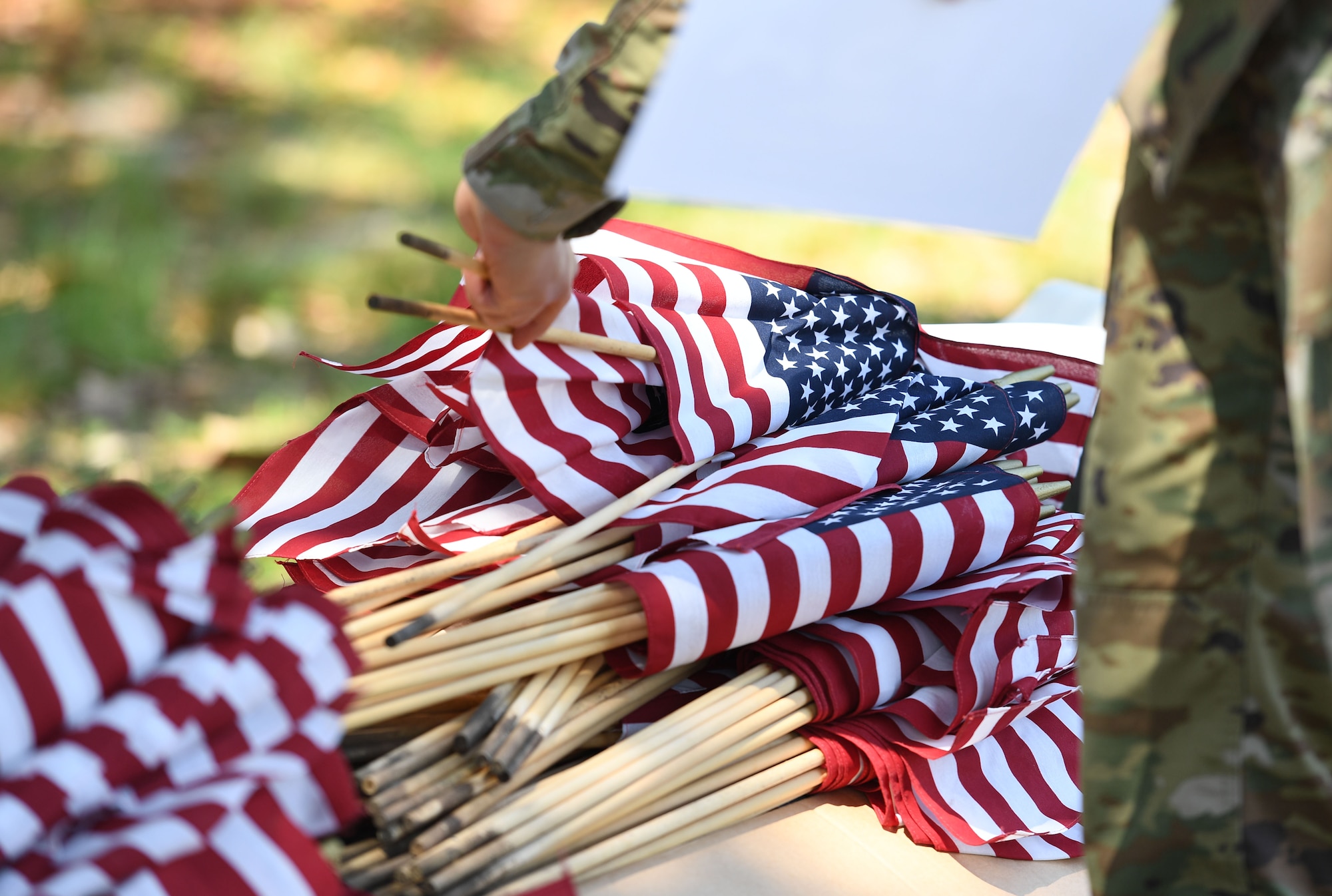 A member of the Air Force Sergeants Association Chapter 652 prepares to place U.S. flags in the ground along Larcher Blvd. at Keesler Air Force Base, Mississippi, June 11, 2021. June 14 is Flag Day, a celebration of the history of the American flag and a time to remember proper etiquette for its display. Flag Day recognizes the adoption of the Stars and Stripes as the official flag of the United States 238 years ago on June 14, 1777, by the Continental Congress meeting in Philadelphia. (U.S. Air Force photo by Kemberly Groue)