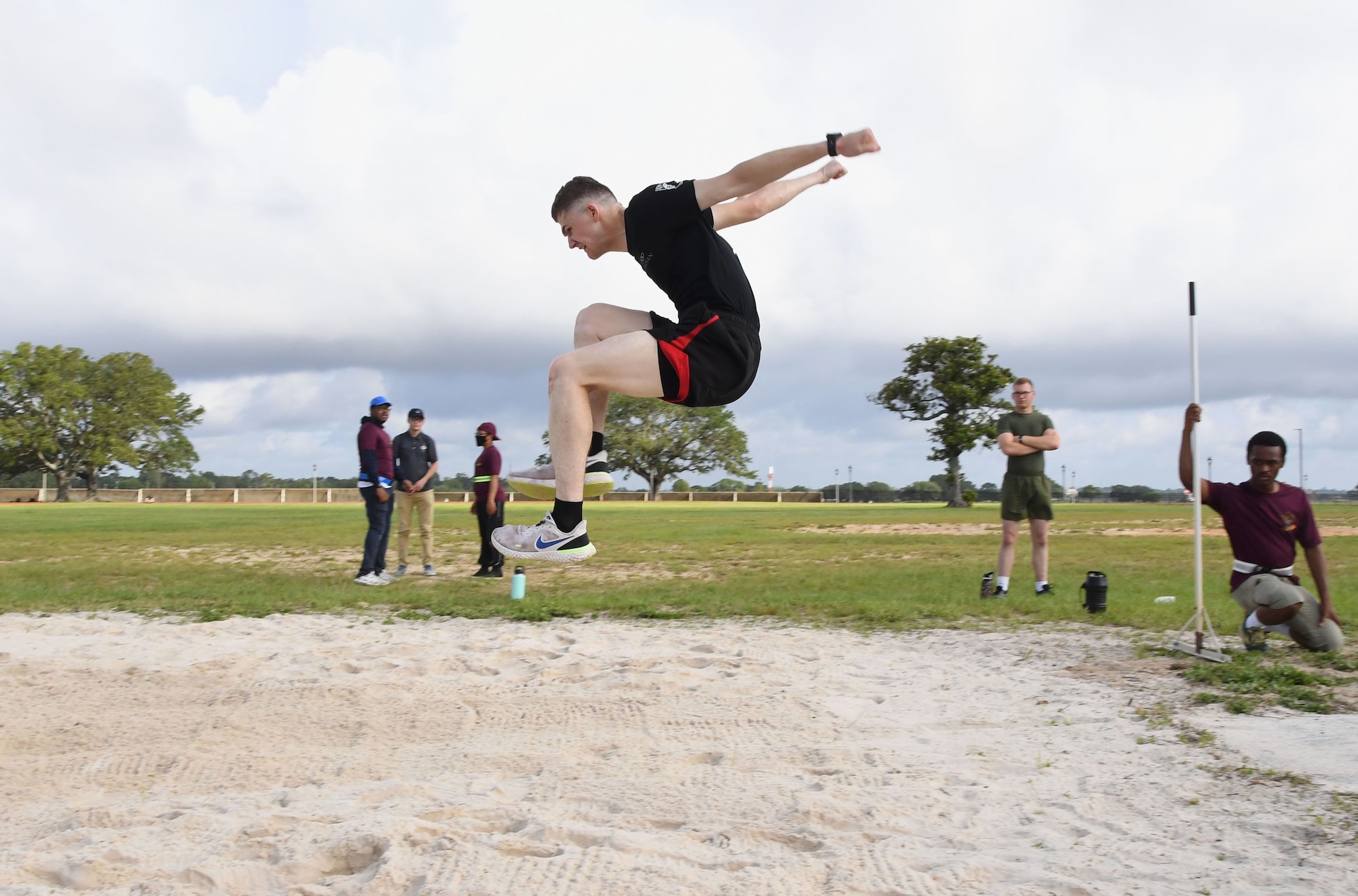 U.S. Air Force Airman Spencer Mullins, 338th Training Squadron student, participates in long jump during the 81st Training Group Olympics at Keesler Air Force Base, Mississippi, June 11, 2021. The event also included competitions in weight lifting, track, shot put and discus. (U.S. Air Force photo by Kemberly Groue)