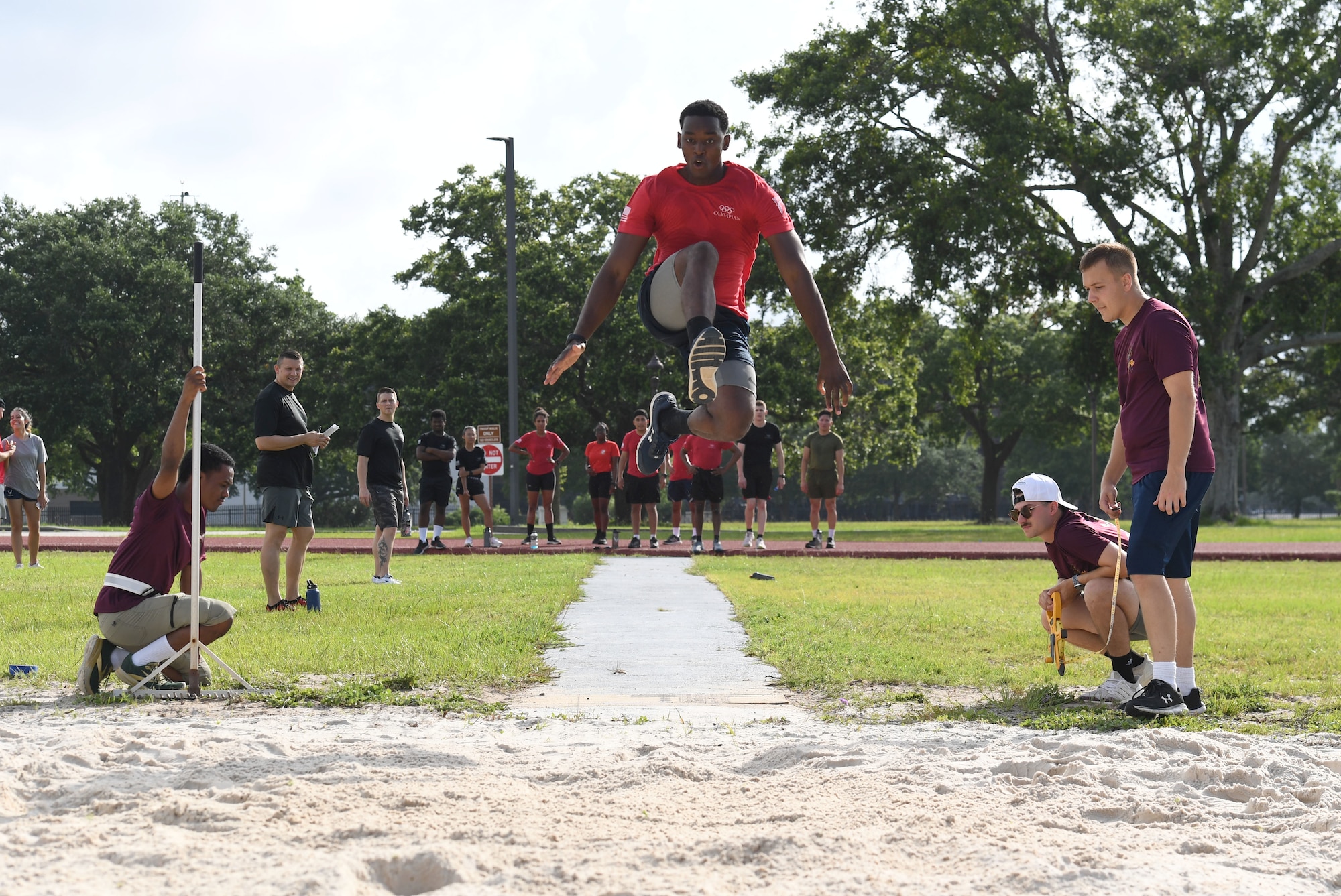 U.S. Air Force Airman 1st Class McLee Emile, 336th Training Squadron student, participates in long jump during the 81st Training Group Olympics at Keesler Air Force Base, Mississippi, June 11, 2021. The event also included competitions in weight lifting, track, shot put and discus. (U.S. Air Force photo by Kemberly Groue)