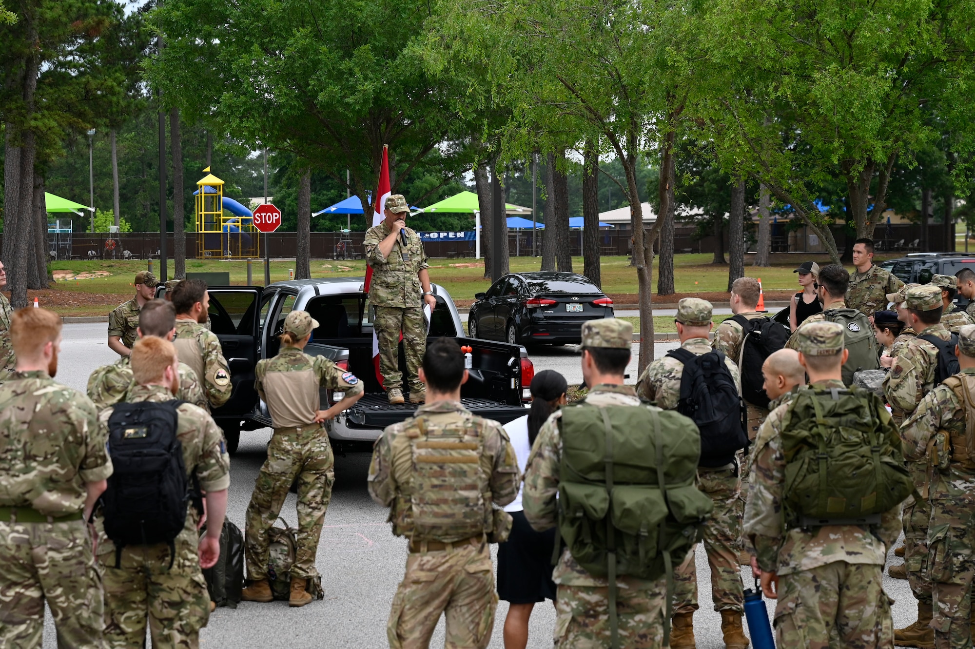 Royal Danish Air Force Lt. Col. John Roland Pedersen briefs rules and safety guidelines to members from the U.S. Air Force, U.S. Army, and Royal Danish Air Force as they prepare to begin the inaugural Danish Contingency, or DANCON, ruck march at Shaw Air Force Base, S.C., June 5, 2021. RDAF members recently deployed to Shaw Air Force Base to work side by side with Airmen from the 727 Expeditionary Air Control Squadron. This event marks the first DANCON march held on U.S. soil. Traditionally, RDAF members host 25 km (15.5 miles) DANCON ruck marches at the conclusion of team deployments in the Middle East and other locations around the globe.