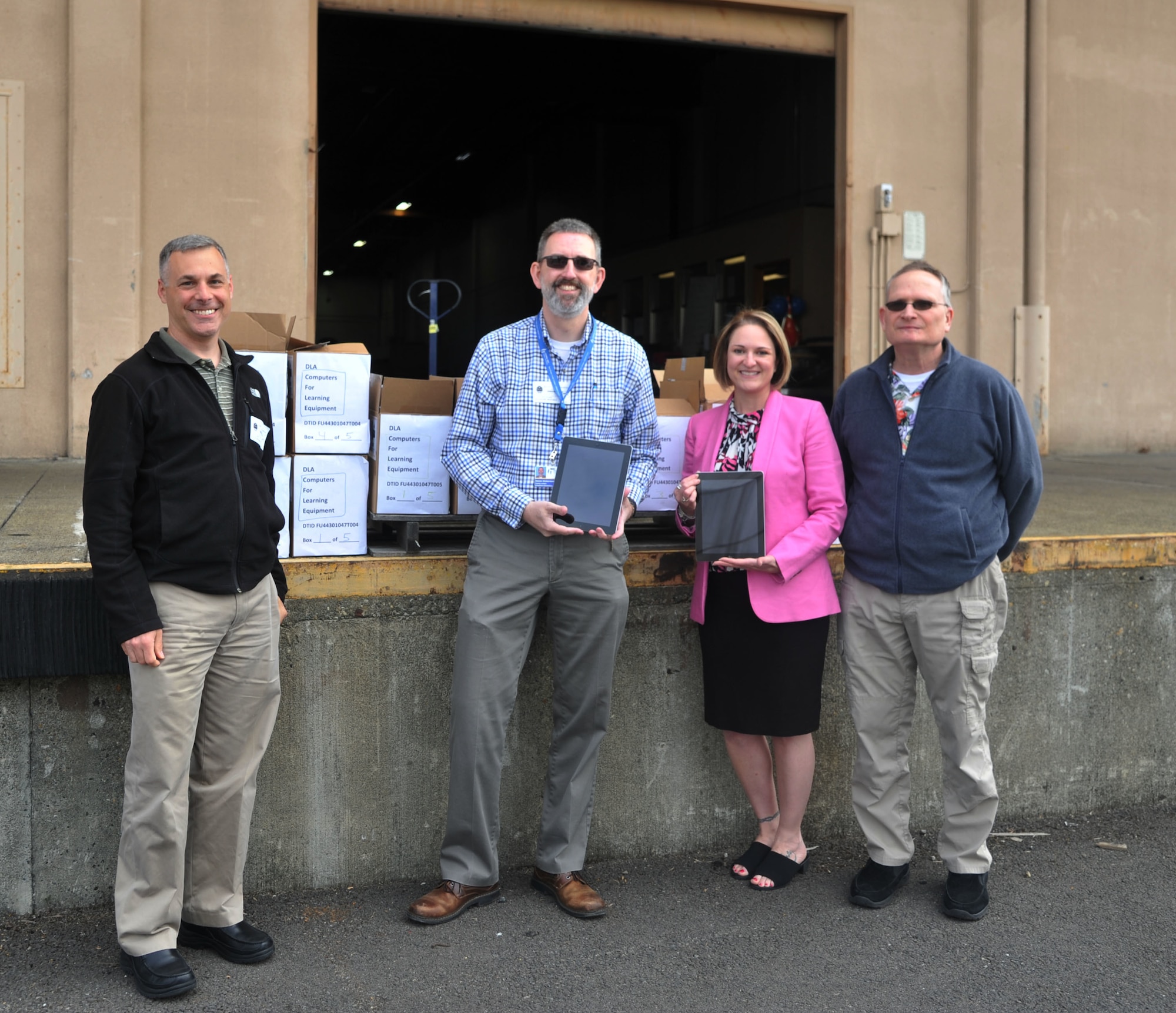 Brigadoon principal and family liaison take photo after receiving 96 iPad tablets through the Computers for Learning Program.