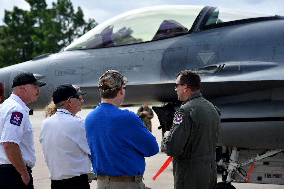 (right) Col. Korey “Axe” Amundson, 301st Fighter Wing vice commander, describes an F-16 Fighting Falcon for Dallas/Fort Worth civic leaders on June 11, 2021, at U.S. Naval Air Station Joint Reserve Base Fort Worth, Texas. The F-16 Fighting Falcon is a compact, multi-role fighter aircraft. It is highly maneuverable and has proven itself in air-to-air combat and air-to-surface attack. (U.S. Air Force photo by Staff Sgt. Randall Moose)