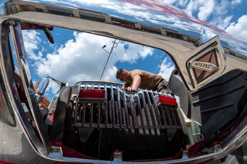 Construction Mechanic 3rd Class Corey Mason, of Hermiston, Oregon, Transportation Floor supervisor, troubleshoots a fuse.