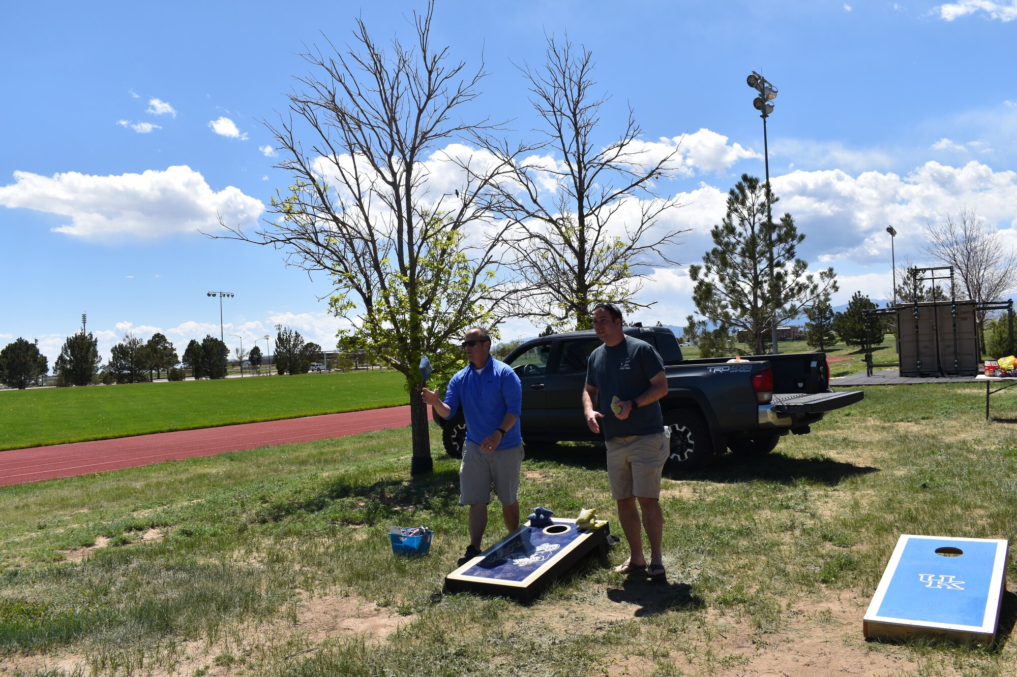 Members play corn hole during picnic