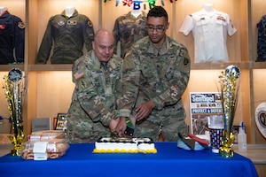 Military members cut Army birthday cake with sword