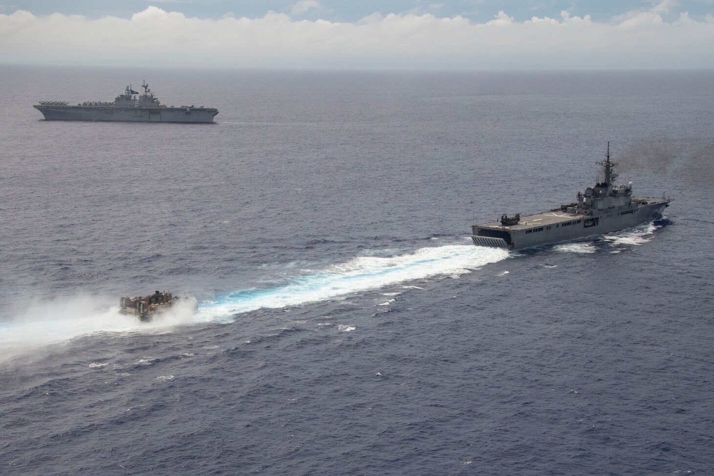 PHILIPPINE SEA (June 13, 2021) Japan Maritime Self Defense Force tank landing ship JDS Shimokita (LST 4002), right, prepares to recover a landing craft, air cushion after bilateral operations with the America Amphibious Ready Group (ARG) and 31st Marine Expeditionary Unit (MEU). The America ARG, along with the 31st MEU, is operating in the U.S. 7th Fleet area of operations to enhance interoperability with allies and partners and serve as a ready response force to defend peace and stability in the Indo-Pacific region.