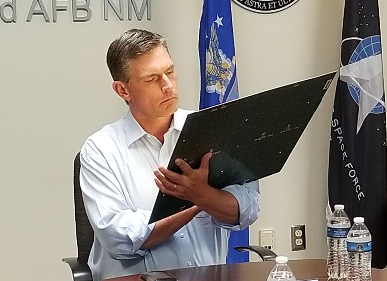 U.S. Senator Martin Heinrich (D-NM) examines a solar-to-radio frequency conversion tile June 3 that will be used as part of a larger constellation of panels to capture the sun’s energy on orbit, and beam it to the ground for on-demand power. (Courtesy photo)