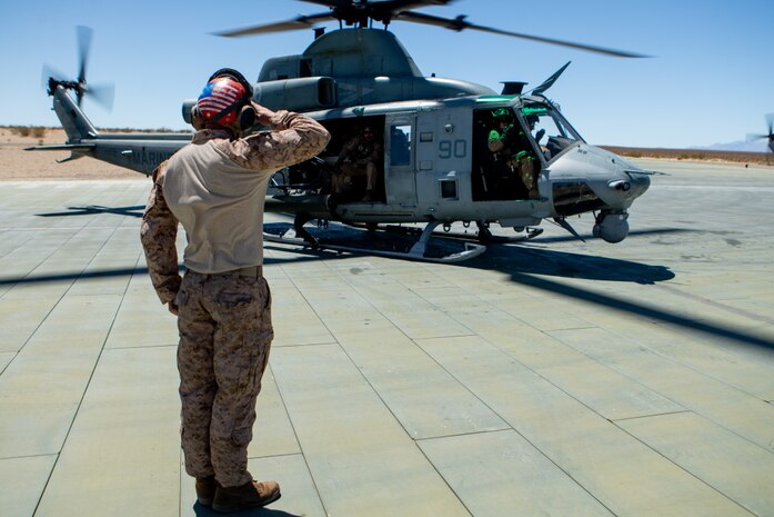 U.S. Marine Corps Lance Cpl. Timonthy P. Gensitskiy, an ordnance team member with Marine Light Attack Squadron 269, signals to pilots that a UH-1Y Venom helicopter’s weaponry has been disarmed after a flight at Marine Corps Air-Ground Combat Center Twentynine Palms, California, April 28, 2021. HMLA-269 and other squadrons assigned to Marine Aircraft Group 29 are training to integrate with and support various Marine ground units as part of Service Level Training Exercise 3-21. SLTE is a series of exercises designed to prepare Marines for operations around the globe by increasing their ability to operate and conduct offensive and defensive combat operations. MAG-29 is a subordinate unit of 2nd Marine Aircraft Wing, the aviation combat element of II Marine Expeditionary Force.