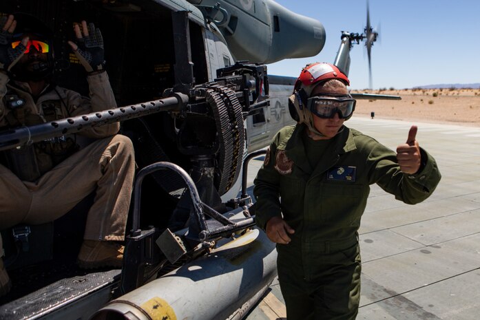 U.S. Marine Corps Lance Cpl. Lauren M. Young, right, an ordnance team member with Marine Light Attack Squadron 269, and Sgt. Lorenzo J. Gaines, an aerial observer with HMLA-269, signal that an M2 machine gun is disarmed at Marine Air-Ground Combat Center Twentynine Palms, California, April 28, 2021. HMLA-269 and other squadrons assigned to Marine Aircraft Group 29 are training to integrate with and support various Marine ground units as part of Service Level Training Exercise 3-21. SLTE is a series of exercises designed to prepare Marines for operations around the globe by increasing their ability to operate and conduct offensive and defensive combat operations. MAG-29 is a subordinate unit of 2nd Marine Aircraft Wing, the aviation combat element of II Marine Expeditionary Force.