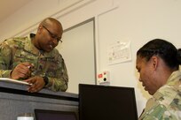Cpt. Sibusiso Ntuli, left, health service systems management officer with 3rd Medical Command (Deployment Support) speaks with Cpt. Jessica Bradford, patient administration officer with the 3rd MC (DS) about future operations during a medical command post exercise, part of Defender Europe 21, on Daenner Kaserne in Kaiserslautern, Germany June 11, 2021. Defender Europe 21 is an annual large-scale U.S. Army Europe and Africa-led joint, multinational exercise designed to build readiness and interoperability between U.S., NATO and partner militaries.  (U.S. Army photo by Staff Sgt. Chris Jackson)