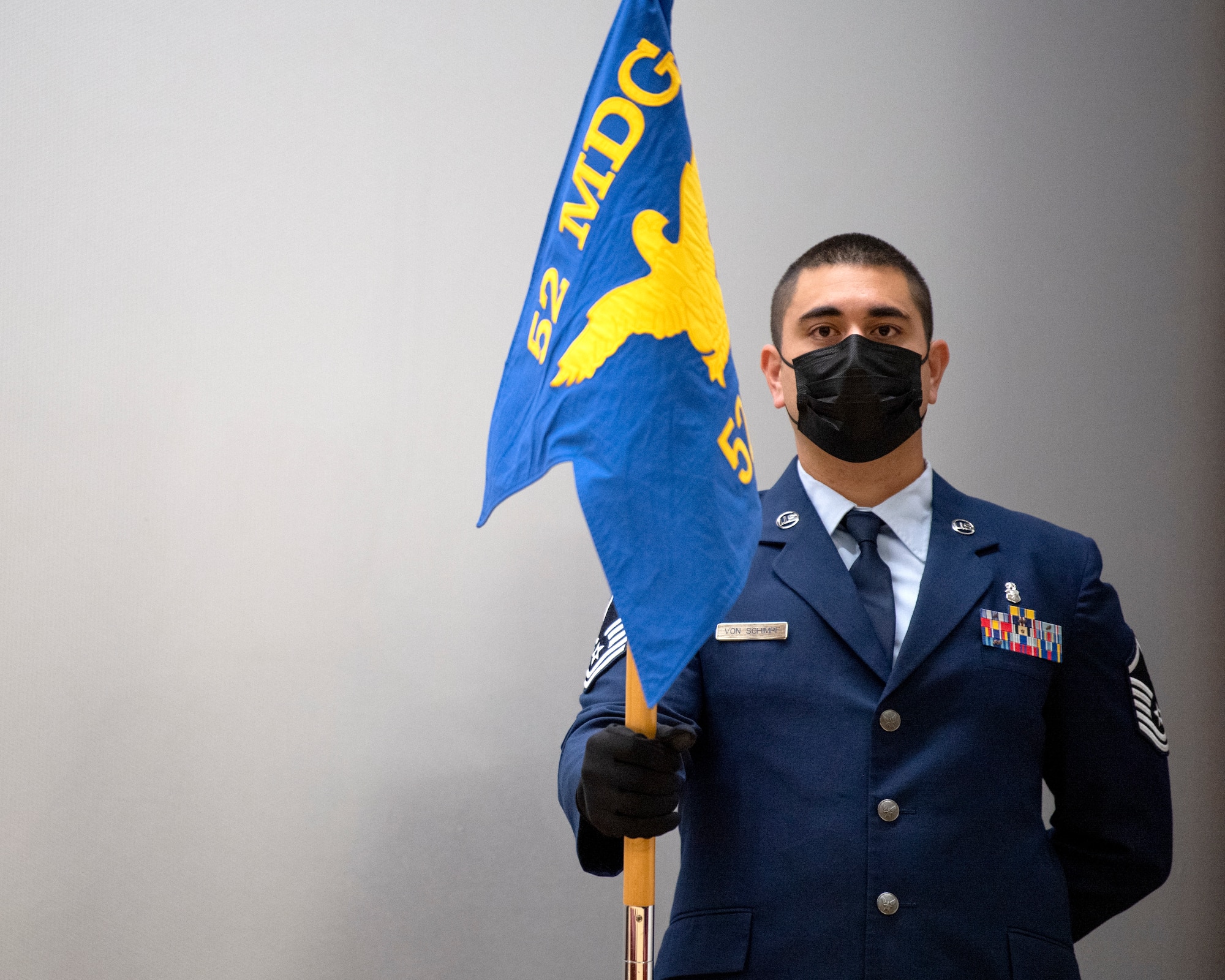 Guidon bearer holds the 52nd Dental Squadron guidon during the 52nd DS deactivation ceremony.