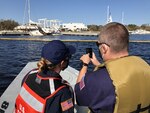 Coast Guard Petty Officer 1st Class Alysha Nagel, and Petty Officer 2nd Class Garrett Ragland conduct post Hurricane Sally assessments to determine environmental threats posed by vessels, in Perdido Bay in Lillian, Alabama, Oct. 3, 2020. Marine Environmental Response teams validated vessel statuses from initial data collected immediately following the hurricane. U.S. Coast Guard photo by Chief Petty Officer Melissa Leake.