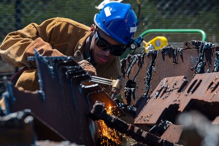 U.S. Air Force Staff Sgt. Sadonta Cole, a firefighter with the 188th Wing at Ebbing Air National Guard Base in Fort Smith, Ark., trains using various methods to cut metal with a torch at the REACT Center during PATRIOT 21 at Volk Field Combat Readiness Training Center, Wis., June 13, 2021. PATRIOT 21 is an annual, accredited Joint National Training Capability exercise that provides a simulated natural disaster environment for units to test their response and capabilities to conduct domestic operations.