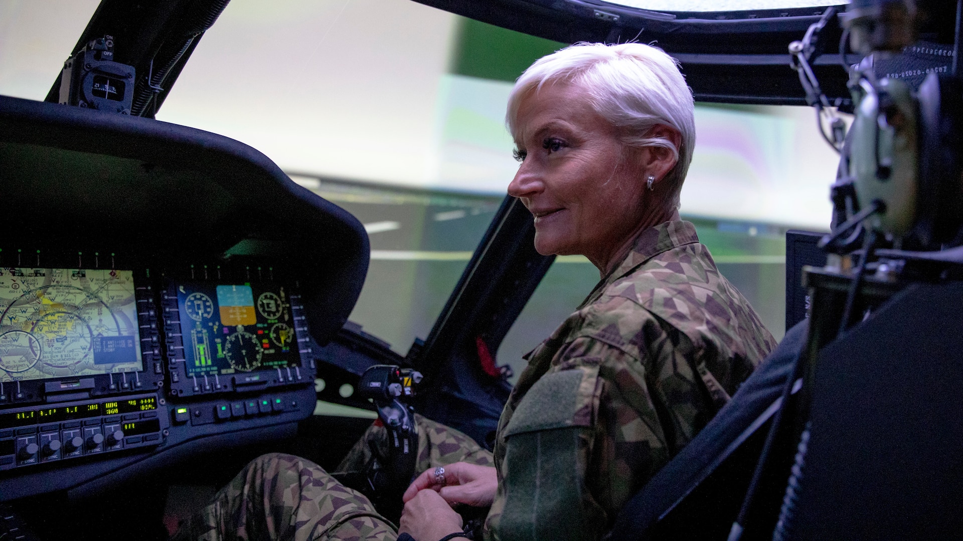 Latvian National Armed Forces Col. Ilze Žilde sits in a UH60 Black Hawk aircrew trainer assigned to the 3rd Battalion, 238th Aviation Regiment, General Support Aviation Battalion, Michigan Army National Guard, at the Army Aviation Support Facility in Grand Ledge, Michigan, May 25, 2021. Leaders of the Latvian military toured Michigan National Guard facilities as part of the State Partnership Program.