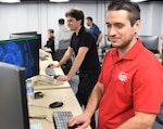 IMAGE: From left to right, Naval Sea Systems Command Red Team members David McDuffie and Kolby Hoover showcase their skills during a tour of the Naval Surface Warfare Center Dahlgren Division Cyber Warfare Engineering Lab.