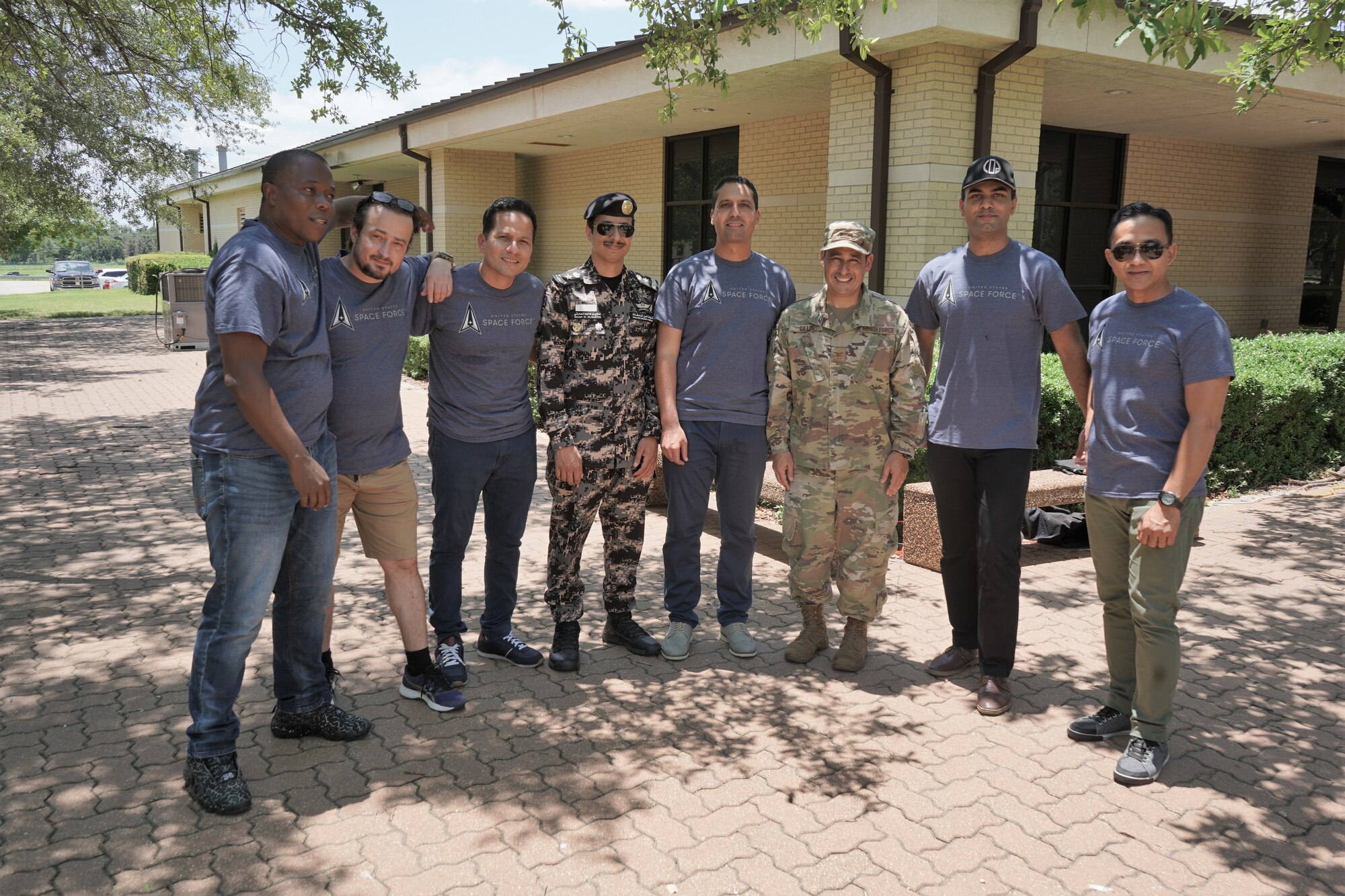 Students and Col Gillis pose for photo outside at AMIGO picnic.