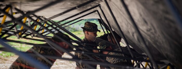 U.S. Marines with Task Force Koa Moana 21, I Marine Expeditionary Force, set up a tent during a communications exercise on Marine Corps Base Camp Pendleton, California, May 12, 2021.