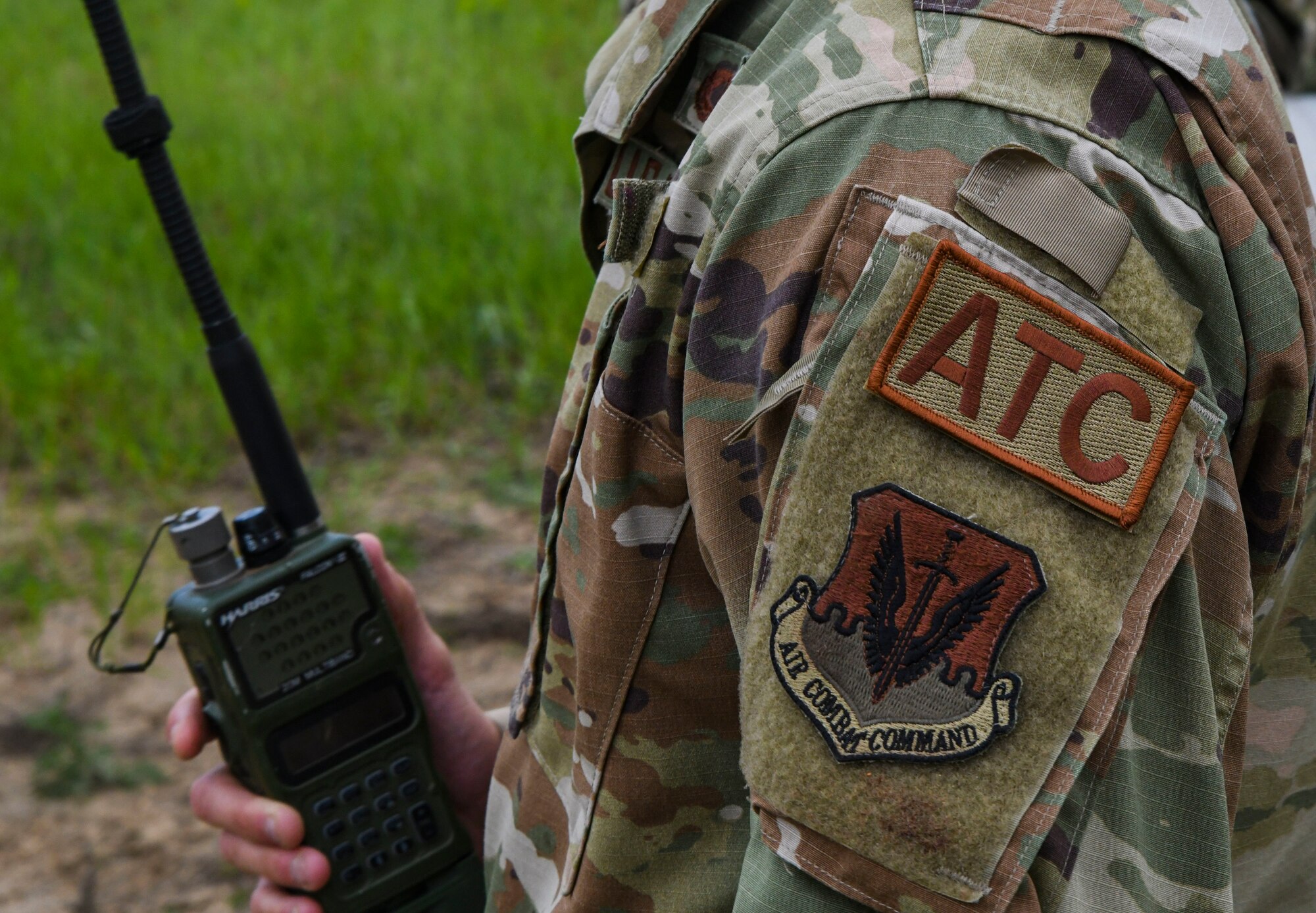 A photo of an airmen holding a radio