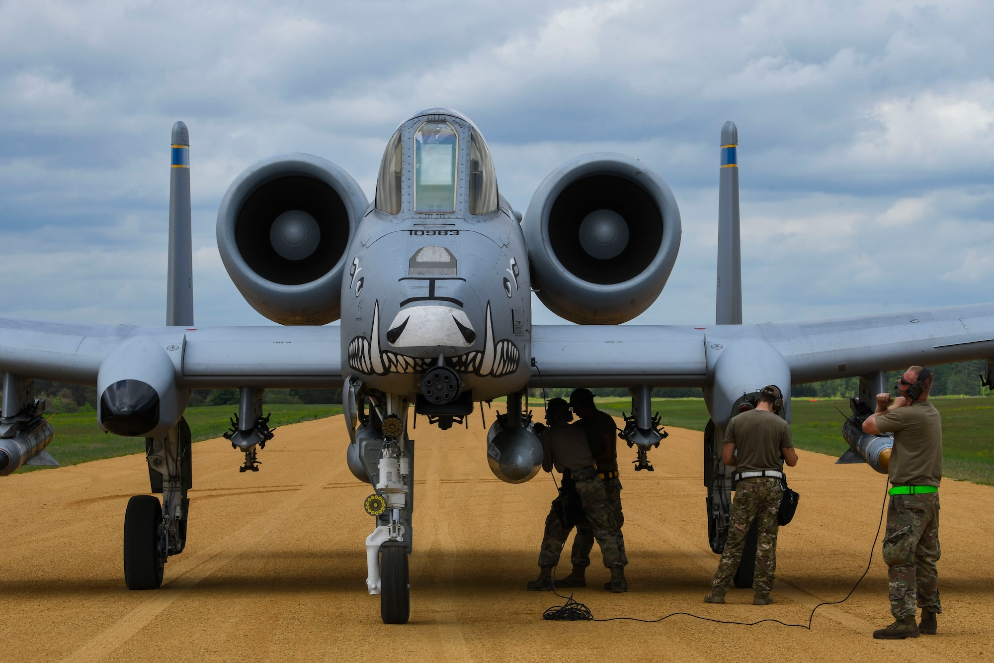 A photo of an aircraft on a dirt runway