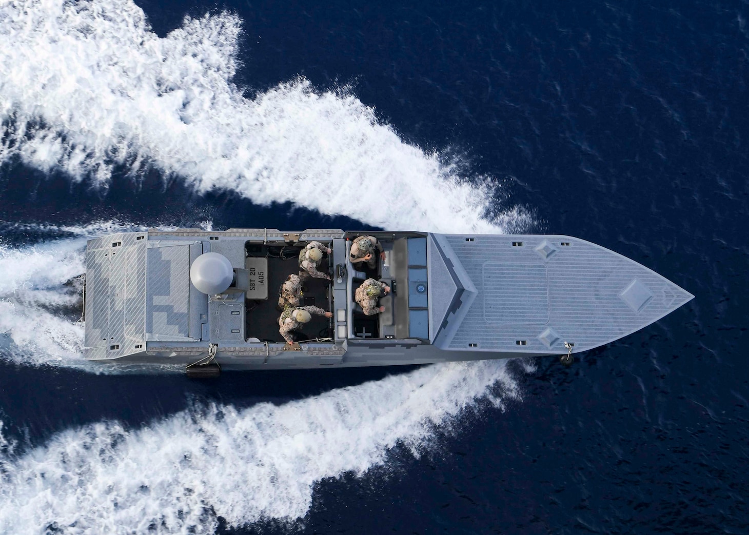 A combatant craft assault craft assigned to Special Boat Team twenty steams alongside the Expeditionary Sea Base USS Hershel 