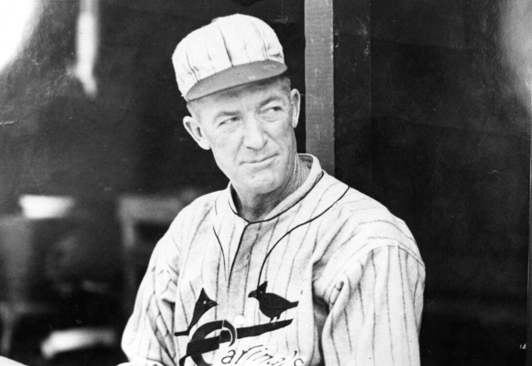 A baseball player looks off into the distance.