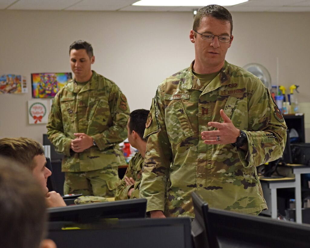 U.S. Air Force Capt. Perry Byrd and Capt. Tyler Sumrall, 315th Training Squadron instructors, mentor students in the 14N Intelligence Officer course, on Goodfellow Air Force Base, Texas, June 6, 2021. Byrd and Sumrall utilized Goodfellow’s unique partnerships which allows course graduates to transfer 12-15 credit hours towards a variety of approved graduate level programs for free. (U.S. Air Force photo by Senior Airman Abbey Rieves) *NOTE: This photo has been edited to distort computer classification markers.