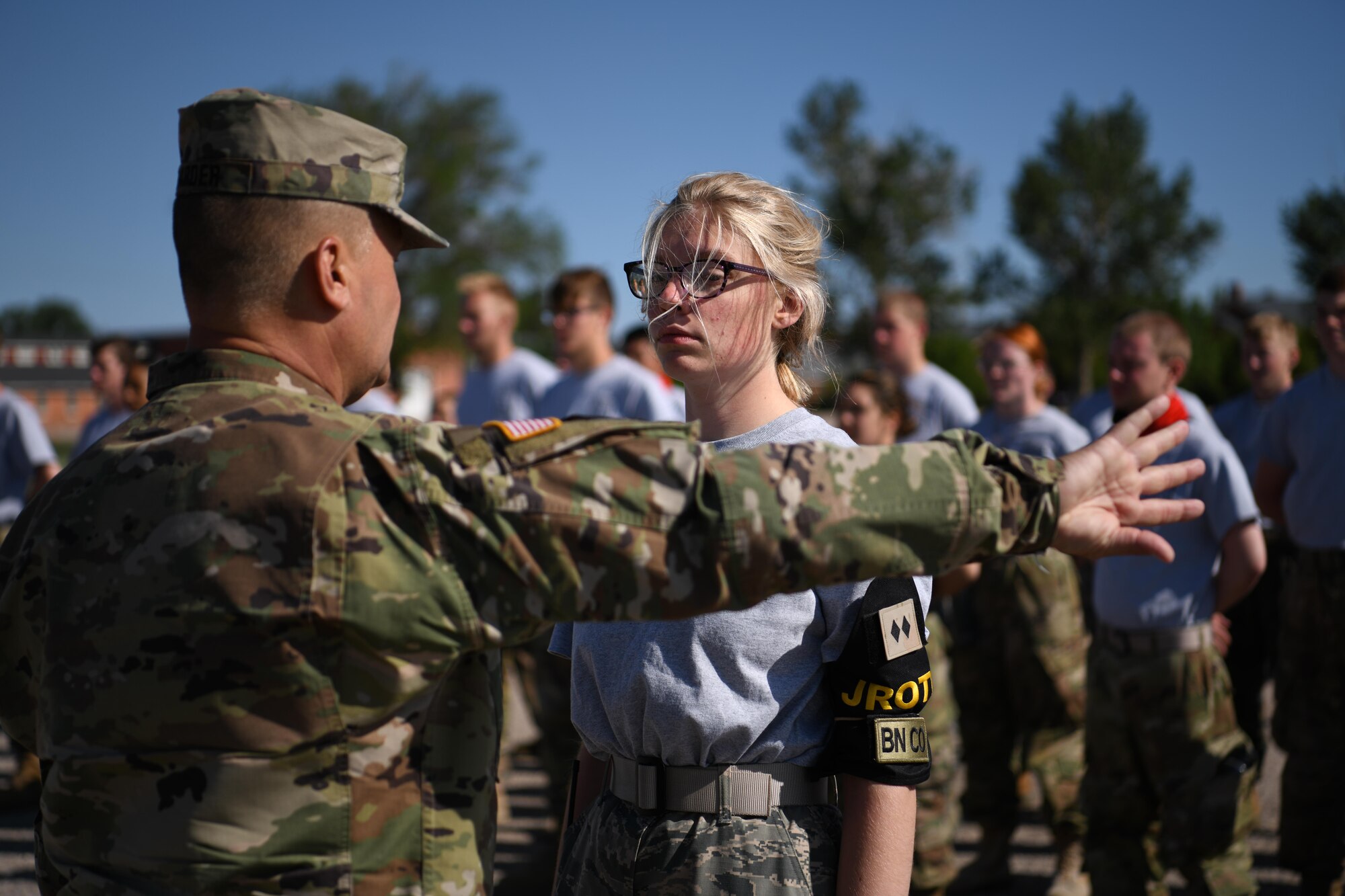 U.S. Army Sgt. Maj. Rodger Harder, instructor for Cheyenne Central High School Army Junior ROTC, instructs Willow Wilson, West Minister High School Air Force Junior ROTC cadet, at F.E. Warren Air Force Base, Wyoming, June 11, 2021. Junior ROTC cadets from five high schools throughout Colorado and Wyoming came to F.E. Warren AFB during Junior ROTC Cadet Leadership Camp. JCLC is a program designed to develop community involvement and leadership skills of high school students. (U.S. Air Force photo by Airman 1st Class Charles Munoz)