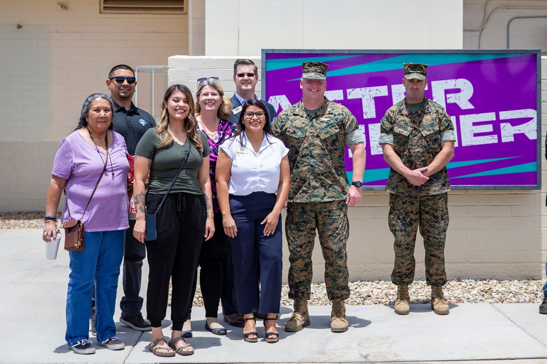 Marine Corps Air Station Yuma Commanding Officer, Col Charles E. Dudik, alongside MCCS personnel, poses for a photo during the official opening of the Afterburner restaurant aboard MCAS Yuma, Ariz., June 10, 2021.