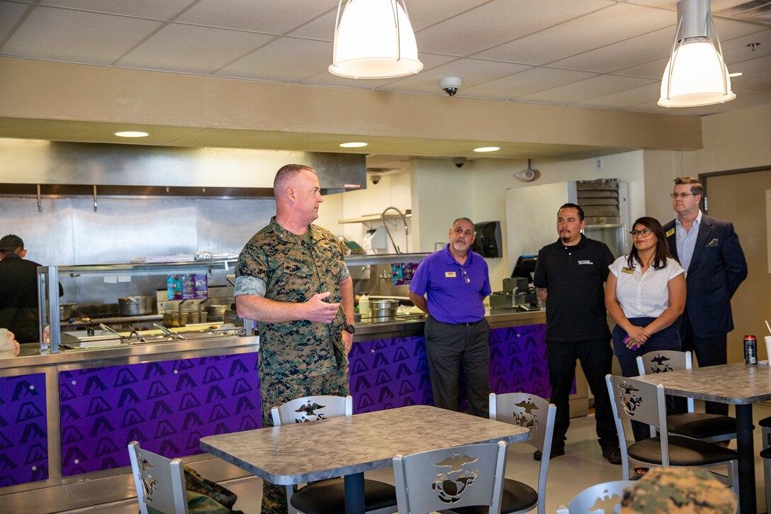 Marine Corps Air Station Yuma Commanding Officer, Col. Charles E. Dudik,  congratulates workers during the official opening of the Afterburner restaurant aboard MCAS Yuma, Ariz., June 10, 2021.