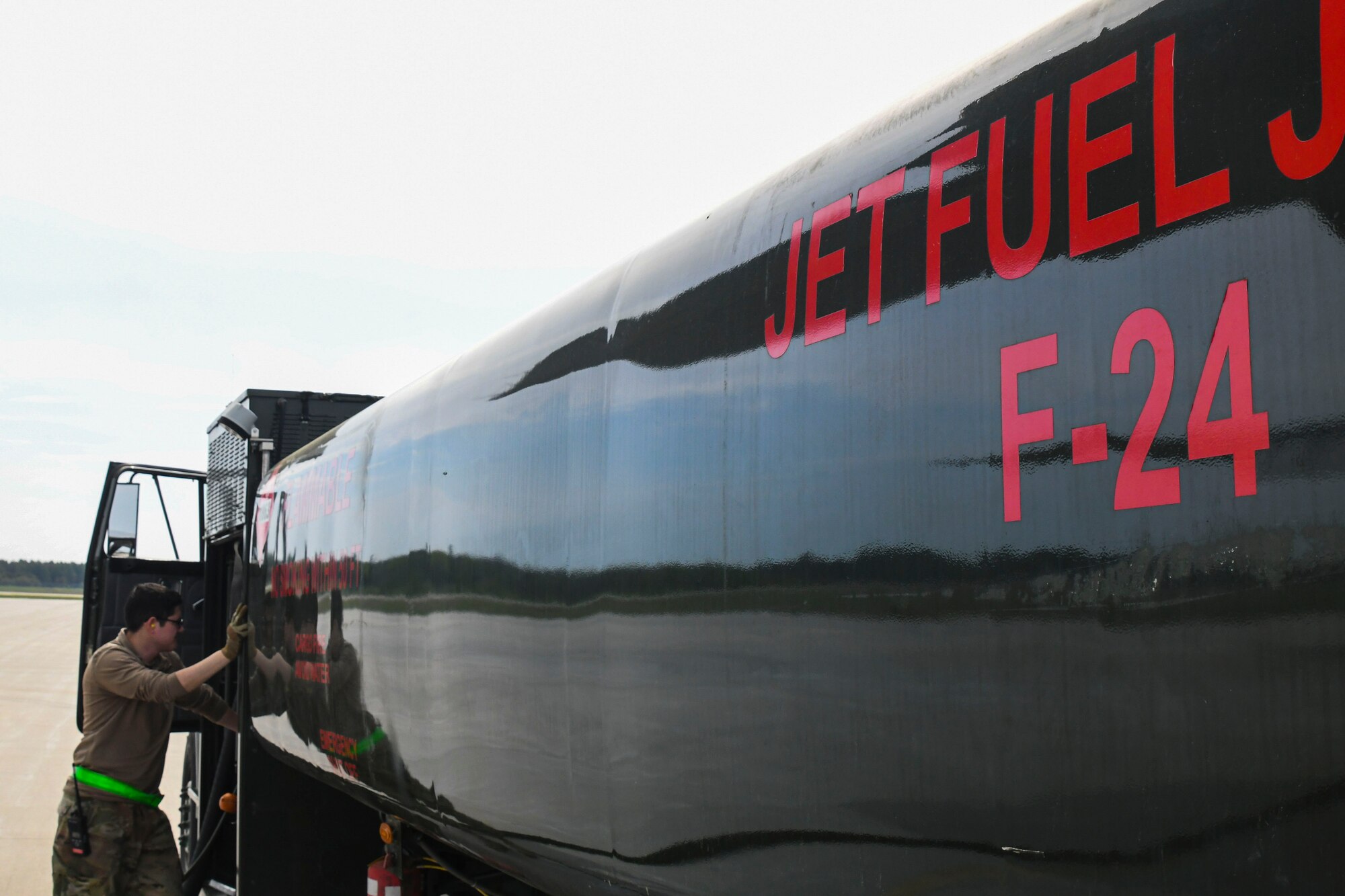 A photo of an airman prepping a fuel truck