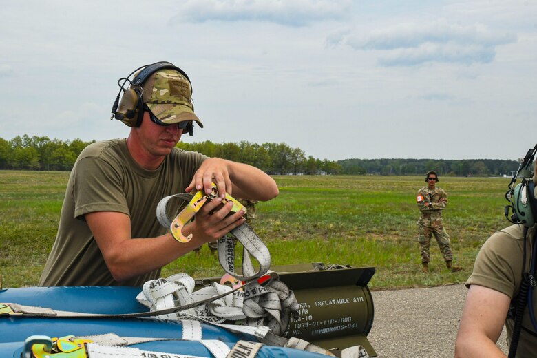A photo of an airmen prepping munitions for loading