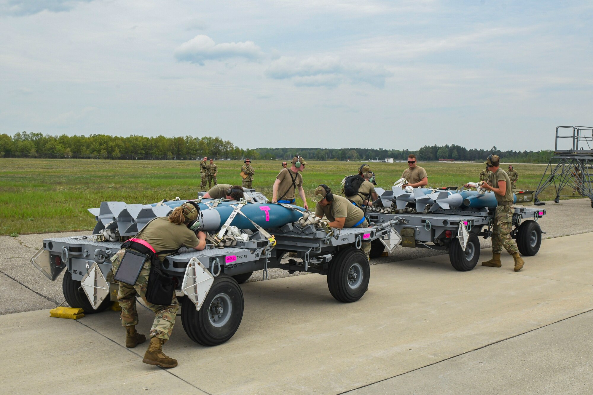 A photo of airmen prepping munitions for loading